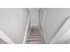 Carpeted staircase with white walls and trim leading down to the next level at 1139 E 35Th St, Indianapolis, IN 46205