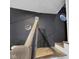 Stylish stairwell featuring a black accent wall with geometric trim, natural wood stairs, and modern railing at 1139 E 35Th St, Indianapolis, IN 46205
