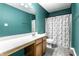 Stylish bathroom with a modern sink, toilet, and a shower with a decorative curtain at 11958 Logan Hunter Trl, Noblesville, IN 46060