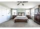 Comfortable bedroom featuring a ceiling fan, soft carpet, and windows to let in natural light at 11958 Logan Hunter Trl, Noblesville, IN 46060