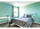 Inviting bedroom with calming blue walls, comfortable bed, and a window offering neighborhood views at 11958 Logan Hunter Trl, Noblesville, IN 46060