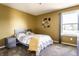Cozy bedroom with neutral tones, plush carpet, and a bright window offering natural light at 11958 Logan Hunter Trl, Noblesville, IN 46060