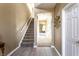 Hallway view with stairs, neutral paint, tile flooring, and an open doorway to another room at 11958 Logan Hunter Trl, Noblesville, IN 46060