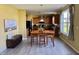 Eat-in kitchen with wooden cabinets, tile floors, natural light, and a charming breakfast table at 11958 Logan Hunter Trl, Noblesville, IN 46060
