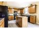 Bright kitchen showcasing an island, wood cabinetry, modern appliances and a functional layout at 11958 Logan Hunter Trl, Noblesville, IN 46060