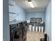 Well-organized laundry room with modern washer and dryer, shelving, and storage options at 11958 Logan Hunter Trl, Noblesville, IN 46060