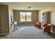 Bright living room with comfortable seating, a desk area, and a large window showcasing outdoor views at 11958 Logan Hunter Trl, Noblesville, IN 46060