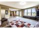 Open-concept living room view showcasing the kitchen, large windows, and a cozy seating area at 11958 Logan Hunter Trl, Noblesville, IN 46060