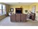 Inviting living room with a large brown reclining sofa, neutral carpet, and a view of large windows at 11958 Logan Hunter Trl, Noblesville, IN 46060