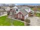 Aerial view of a two-story home with brick and white siding, lush lawn, and attached two-car garage at 12030 Auburn Creek, Zionsville, IN 46077