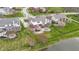 Aerial view of a home showing the backyard, patio, fire pit, and surrounding landscape at 12030 Auburn Creek, Zionsville, IN 46077
