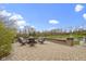 Spacious backyard patio overlooking a pond and fountain, with comfortable seating around a fire pit at 12030 Auburn Creek, Zionsville, IN 46077