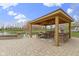 Outdoor gazebo with a built in bar and barbecue area overlooking a water feature and pond at 12030 Auburn Creek, Zionsville, IN 46077