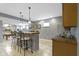 Basement bar area featuring pendant lighting, barstool seating, and tile flooring at 12030 Auburn Creek, Zionsville, IN 46077