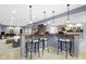Basement bar with seating, pendant lights, and access to a comfortable living space at 12030 Auburn Creek, Zionsville, IN 46077
