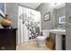 Cozy bathroom with a pedestal sink, framed mirror, and shower with decorative curtain at 12030 Auburn Creek, Zionsville, IN 46077