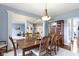 Dining room featuring a wood table and chairs, a china cabinet, and views into the formal living room at 12030 Auburn Creek, Zionsville, IN 46077