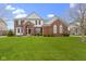 Charming two-story brick home with a well-maintained lawn and mature landscaping in a suburban neighborhood at 12030 Auburn Creek, Zionsville, IN 46077