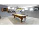 Spacious game room with a classic billiard table and a vintage overhead light fixture at 12030 Auburn Creek, Zionsville, IN 46077