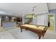 Large game room featuring a pool table with bar access, perfect for entertaining guests at 12030 Auburn Creek, Zionsville, IN 46077
