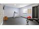 Home gym with rubber flooring, workout equipment, and natural light from the window at 12030 Auburn Creek, Zionsville, IN 46077