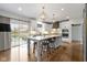Bright kitchen showcases white cabinets, an island with seating, and stainless steel appliances, perfect for modern living at 12030 Auburn Creek, Zionsville, IN 46077