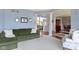 Bright living room with plush seating, neutral carpet, and open floor plan to a formal dining area at 12030 Auburn Creek, Zionsville, IN 46077