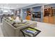 Cozy living room with large sectional, built-in bookshelves, and a modern tiled wall feature at 12030 Auburn Creek, Zionsville, IN 46077