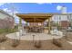 Outdoor kitchen features a built-in grill, seating area, and a beautiful stone patio, perfect for entertaining at 12030 Auburn Creek, Zionsville, IN 46077