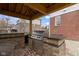 Outdoor kitchen with stainless steel grill and brick surround on a brick patio, ideal for outdoor cooking at 12030 Auburn Creek, Zionsville, IN 46077
