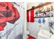 Well-lit bathroom with a tiled shower, sink, open shelving, and a decorative shower curtain at 1270 Eugene St, Indianapolis, IN 46208