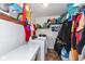Functional laundry room with a washer, dryer, shelving, and storage space at 1270 Eugene St, Indianapolis, IN 46208