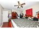 Spacious main bedroom with a Saints-themed bedspread, wooden furniture, and hardwood floors at 1270 Eugene St, Indianapolis, IN 46208