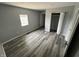 Bedroom featuring neutral paint, new vinyl flooring, a window, and a large closet at 1308 W 18Th St, Indianapolis, IN 46202