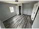 Bedroom with grey walls, new vinyl flooring, a window, and a closet at 1308 W 18Th St, Indianapolis, IN 46202