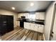 Efficient kitchen with white cabinetry, black appliances, and a complementary countertop for a modern look at 1308 W 18Th St, Indianapolis, IN 46202