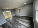 Bright living room with sliding glass doors, grey walls, new vinyl flooring, and recessed lights at 1308 W 18Th St, Indianapolis, IN 46202