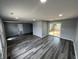 Open concept living room with grey walls, new floors, recessed lighting, and a sliding glass door at 1308 W 18Th St, Indianapolis, IN 46202