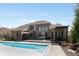 Expansive brick home with a luxurious pool, deck, and outdoor kitchen at 13214 Mink Ln, Carmel, IN 46074