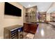 Stylish bar area featuring sleek cabinetry, beverage cooler, and glass shelving for displaying spirits at 13214 Mink Ln, Carmel, IN 46074