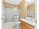 Bathroom featuring shower-tub combo with glass door and wood vanity at 13214 Mink Ln, Carmel, IN 46074