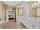 Bright bathroom featuring double sinks, white cabinets, and a bathtub at 13214 Mink Ln, Carmel, IN 46074