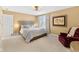 Warm and inviting bedroom with neutral tones, soft carpet, and relaxing armchair at 13214 Mink Ln, Carmel, IN 46074