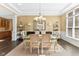 Elegant dining room with a modern chandelier, large windows, and stylish décor at 13214 Mink Ln, Carmel, IN 46074
