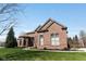 Gorgeous brick house with landscaped front yard and mature trees at 13214 Mink Ln, Carmel, IN 46074