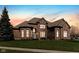 Beautiful brick home with manicured lawn under a colorful sky at 13214 Mink Ln, Carmel, IN 46074