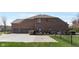 Back of brick house with 2-car garage, fence, and landscaped yard at 13214 Mink Ln, Carmel, IN 46074