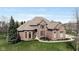 Stunning brick home featuring a manicured lawn and beautiful landscaping at 13214 Mink Ln, Carmel, IN 46074