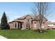 Charming brick house with a well-maintained lawn and mature tree at 13214 Mink Ln, Carmel, IN 46074