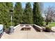 Inviting outdoor fire pit surrounded by mature trees creates a relaxing ambiance at 13214 Mink Ln, Carmel, IN 46074